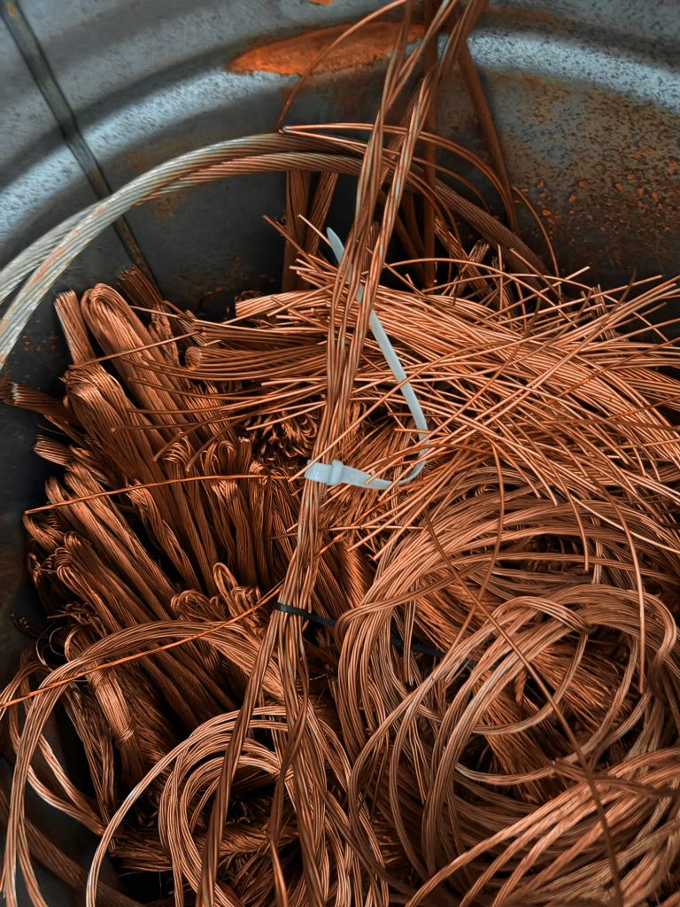 Bright copper wire in a collection bin at the yard